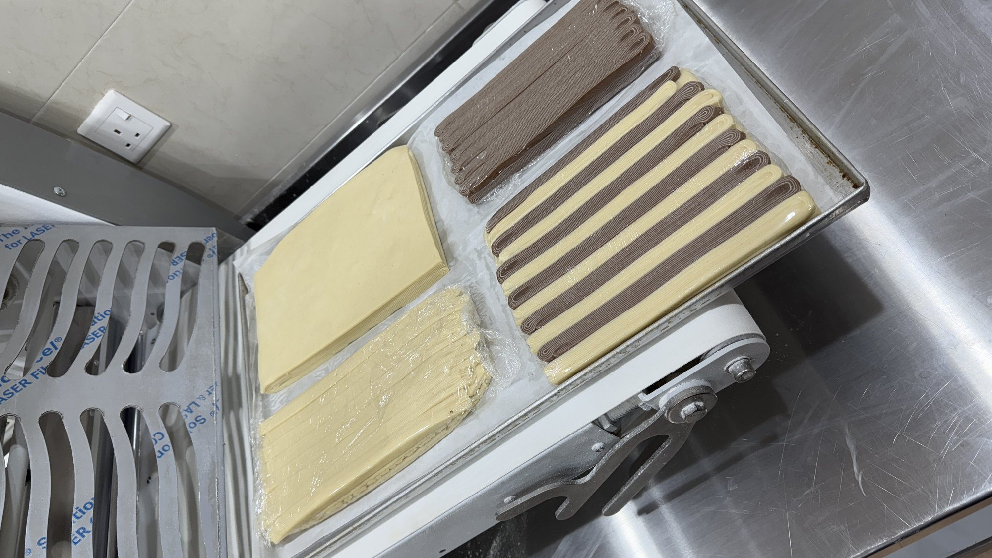 Sheets of raw bicolor laminated dough