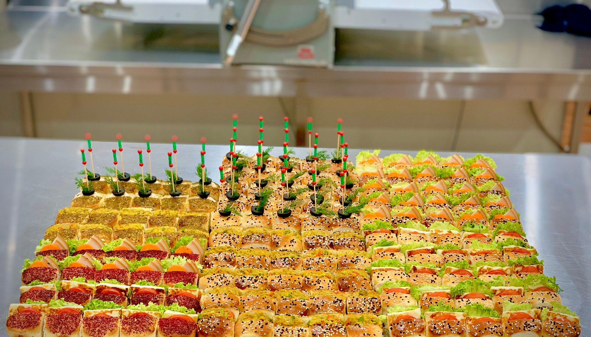 Hundreds of canapés arranged in rows on trays